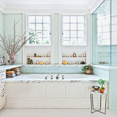 blue and white master bath with a marble-framed tub