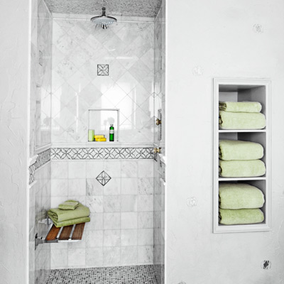 1930s Hollywood Regency-style bath with mosaic tile shower and gray textured plastic walls