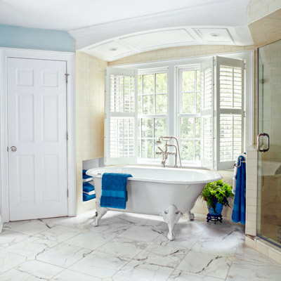 tub alcove with paneled ceiling with recessed lights, marble floor 