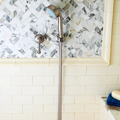 shower with marble mosaic, herringbone tile, ceramic chair-rail and subway tile 