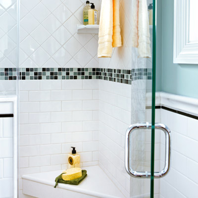narrow small bathroom after remodel with shower with corner seat