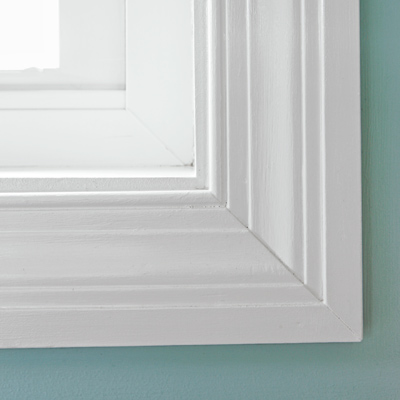 narrow small bathroom after remodel with custom windows with DIY casings