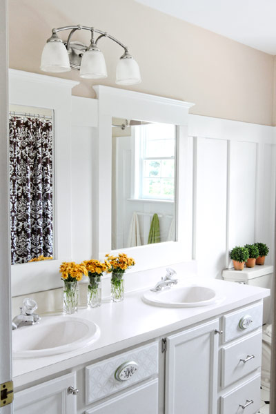 full bath after remodel with simple vanity, nickel fixtures and drawer pulls