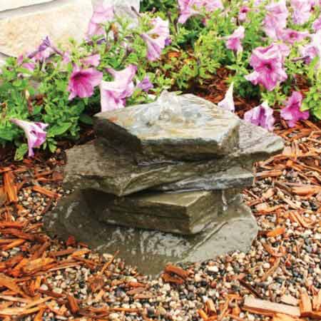 A stack of blue stone pavers in a garden