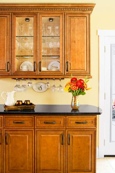 kitchen cabinet with glass panels as makeshift bar