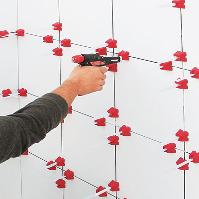 tool identified as a tile leveler for even spacing of wall tiles