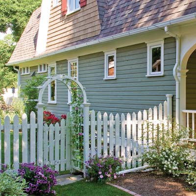 Dutch Colonial porch with surrounding hydrangeas, dogwoods, roses and lilacs