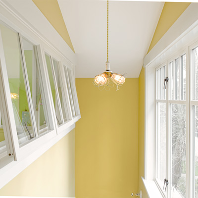 1918 craftsman bungalow after remodel yellow stairwell with awning-style interior windows 