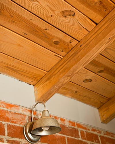 barn light sconce and wood-plant ceiling in open kitchen in cottage whole house remodel 