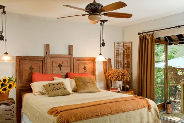 master bedroom with French doors leading out to porch in cottage whole house remodel 