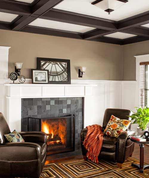 living room of remodeled Craftsman with slate-tile surround and wood mantel