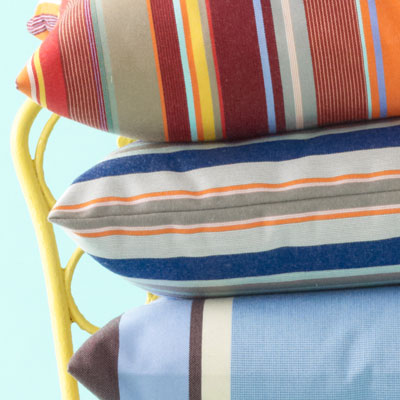 blue, orange, white and gray-striped pillow