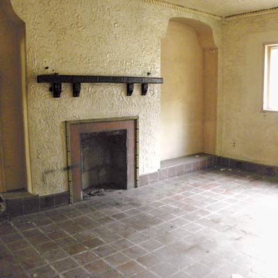 room with a tile floor and stucco walls