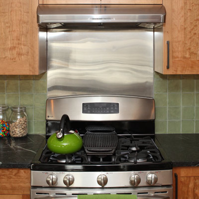metallic range hood in a kitchen 