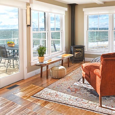 Cape Code living room with hardwood floors and views of waterfront