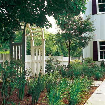 backyard garden arbor double garden gate with spindle-style picket fence