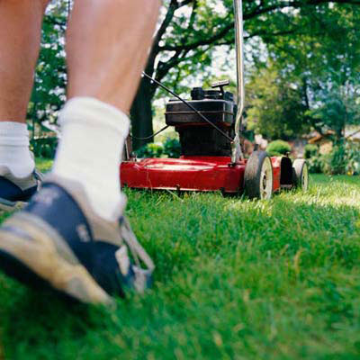 man pushing lawn mower