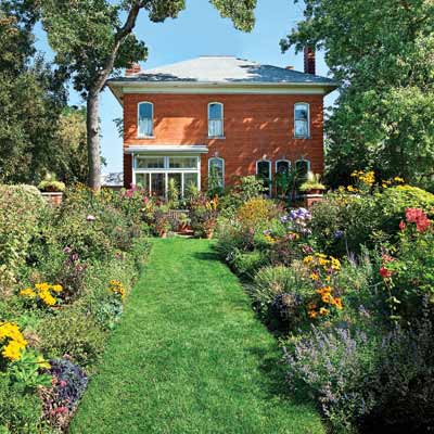 front yard with wide perennial beds and a wide promenade
