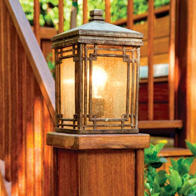 patinated-metal carriage lights on deck posts 