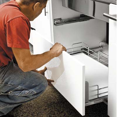 white lacquer cabinets are being placed