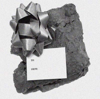 a lump of coal with a bow and gift tag on it