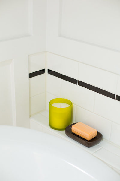 guest bath after redo with tiled shelf for toiletries beside tub