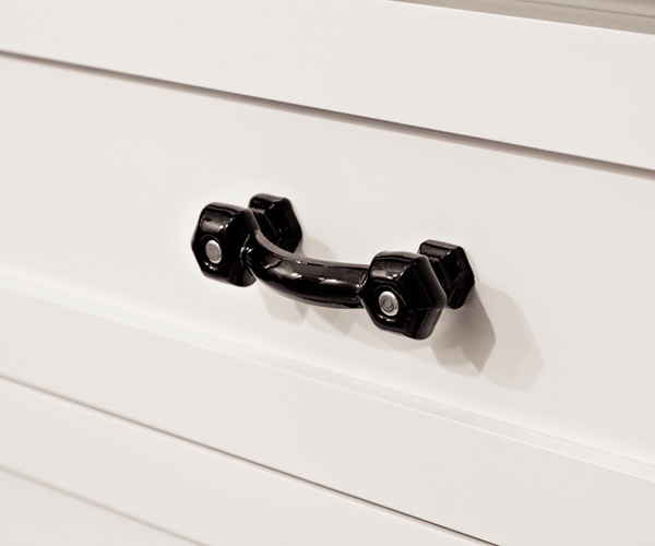 windowless, well-lit guest bathroom with black vintage glass drawer pulls after remodel