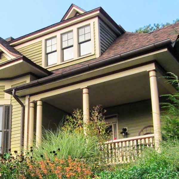 curb appeal boost on budget queen anne style home with copper half-round gutters, rain barrel