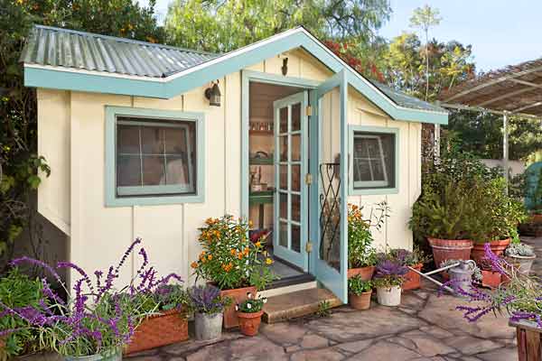 cottage style garden shed used as bonus room with two doors that swing ...