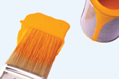 paint brush and paint can with orange paint