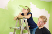 rival siblings painting a room