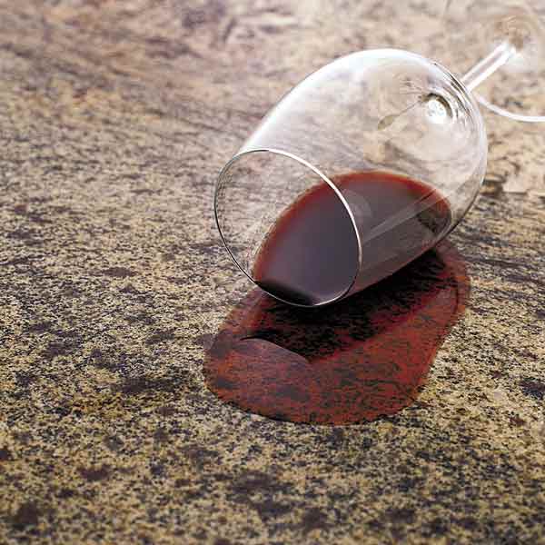 all about stone countertops glass of red wine spilled on stone countertop
