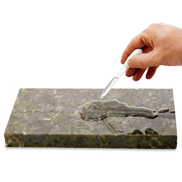 all about stone kitchen countertops person testing countertop surface to see if need for sealing