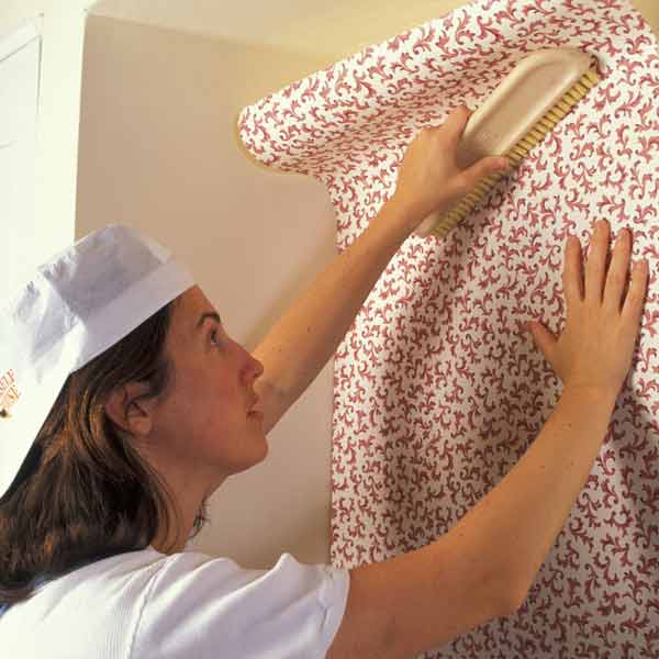 DIY calorie burners woman hanging wallpaper