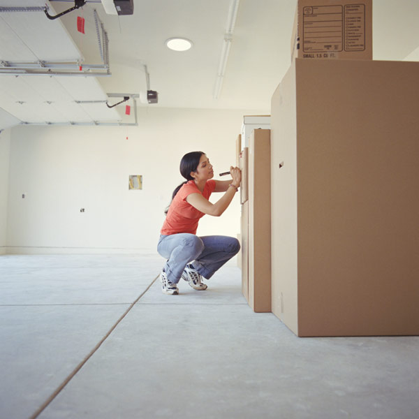 DIY calorie burners woman packing up boxes in a garage
