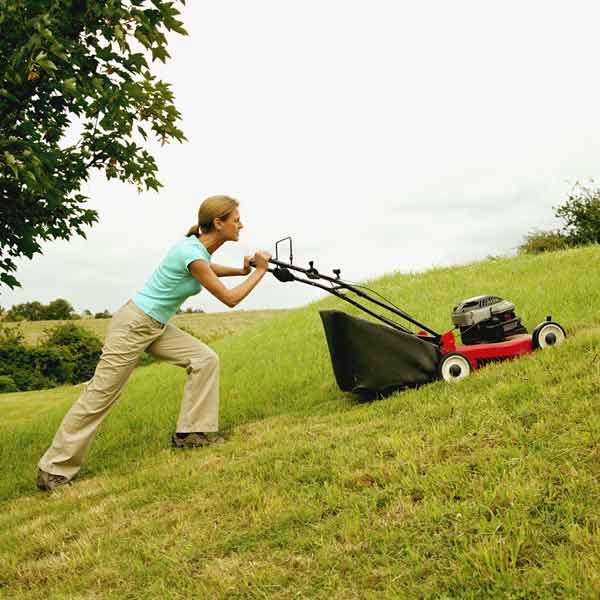 DIY calorie burners woman pushing a lawn mower up a hill