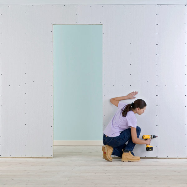 DIY calorie burners woman hanging drywall
