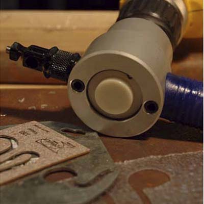 Bad Dog nibbler attaches to the chuck of your drill and shears sheet metal