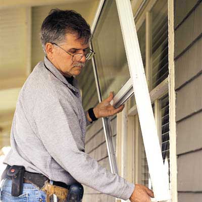 Tom Silva installs a storm window