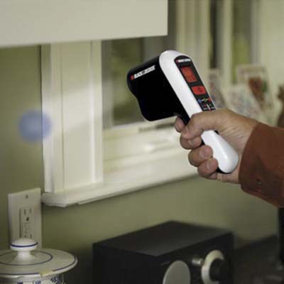 a point-and-shoot thermal detector pointing its laser at a window