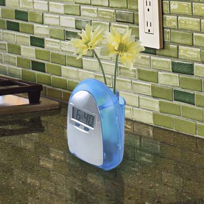 Think Geek water-powered clock with flowers in the back on kitchen counter