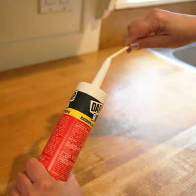 Chopsticks used to clean a tube of caulk