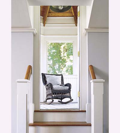 screened-in porch in octagonal tower of new Shingle-style house