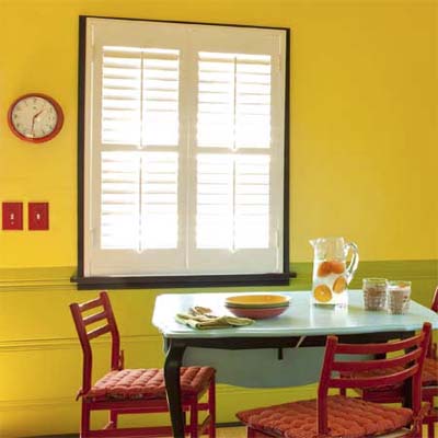 window with white framed in black beyond a dining table