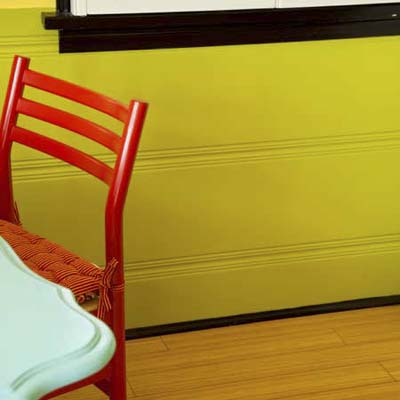 close up of green-painted wainscoting in a kitchen dining area