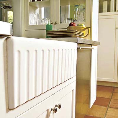 a farmhouse sink in a newly remodeled kitchen