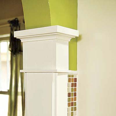 an archway into a newly remodeled kitchen