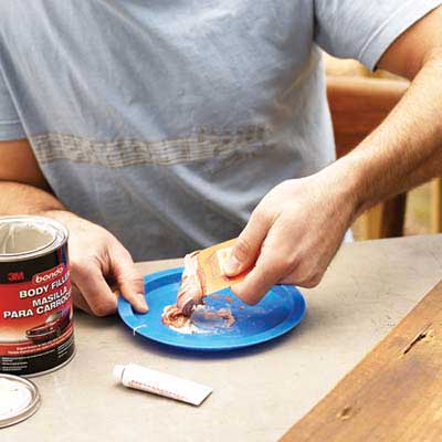 gift card being used to mix patching compound