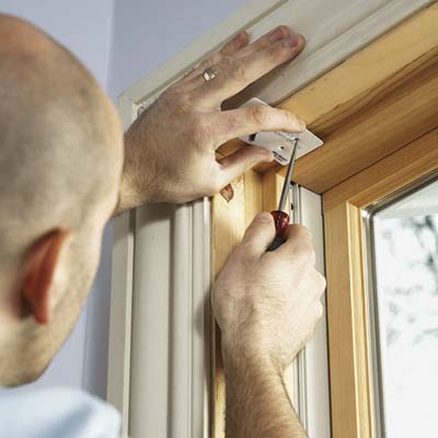 gift card used to mark screw-holes in a window frame