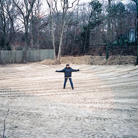 homeowner, Rosi Zingales stands in the middle of her regraded backyard
